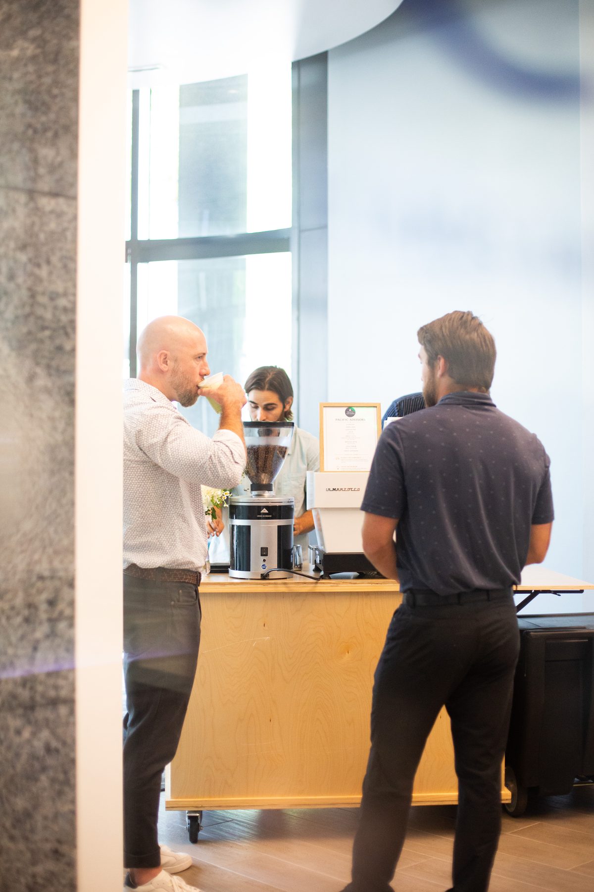 Guests chatting and enjoying drinks around the coffee cart